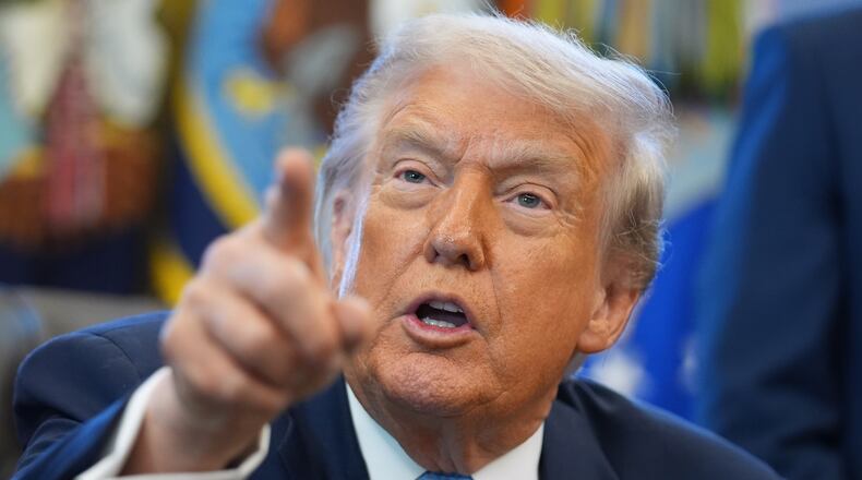 President Donald Trump answers questions from reporters during a meeting with the White House task force on the 2026 FIFA World Cup in the Oval Office of the White House, Monday, Nov. 17, 2025, in Washington. (AP Photo/Evan Vucci)