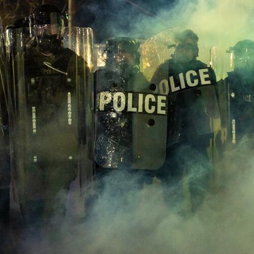 Law Enforcement Officers walk through tear gas chemical irritant during clashes with anti-ICE protesters outside the Delaney Hall detention center on Saturday, May 30, 2026, in Newark, N.J. (AP Photo/Angelina Katsanis)