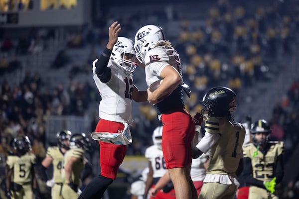Lee County quarterback Marcus Snipes (left) celebrates his touchdown pass to tight end Carter Blackwell during the first-round of the GHSA Class 5A state playoffs at Sprayberry High School on Friday, Nov. 14, 2025, in Marietta. (Jason Getz/AJC)