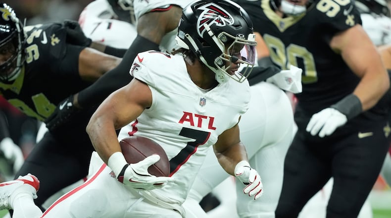 Atlanta Falcons running back Bijan Robinson (7) runs against the New Orleans Saints in the first half of an NFL football game, Sunday, Nov. 23, 2025, in New Orleans. (AP Photo/Gerald Herbert)