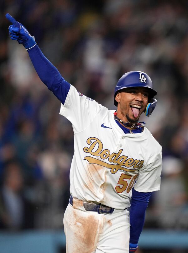 Los Angeles Dodgers shortstop Mookie Betts celebrates as he runs to first after hitting a walk-off three-run home run during the 10th inning of an opening-day baseball game against the Detroit Tigers Friday, March 28, 2025, in Los Angeles. (AP Photo/Mark J. Terrill)