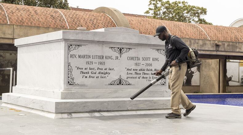 A King Center worker clears debris from the crypt of Martin Luther King Jr. and his wife, Coretta Scott King, at the Martin Luther King Jr. National Historic Park in Atlanta. The King Center and all of Atlanta’s civil right sites are coping with survival in the middle of the coronavirus pandemic ALYSSA POINTER/ALYSSA.POINTER@AJC.COM