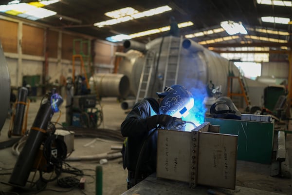 FILE - An employee welds metal at a steel tank factory in Mexico City, Feb. 11, 2025. (AP Photo/Eduardo Verdugo, File)