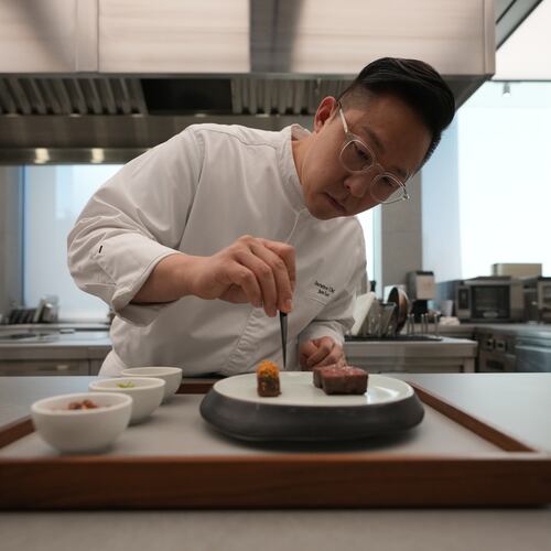 Chef Jun Lee prepares food for a photo at his restaurant SOIGNÉ in Seoul, South Korea, Thursday, Jan. 29, 2026. (AP Photo/Lee Jin-man)