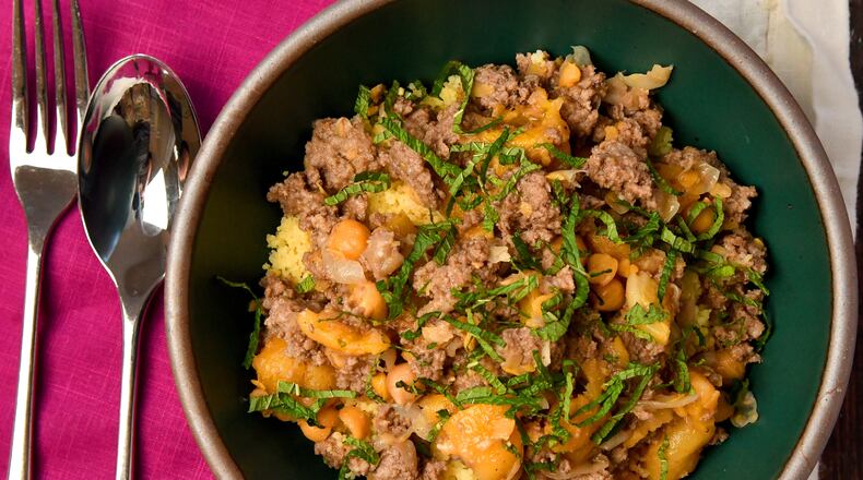 Quick Spiced Lamb Stew, shown here with couscous. (CHRIS HUNT FOR THE ATLANTA JOURNAL-CONSTITUTION)