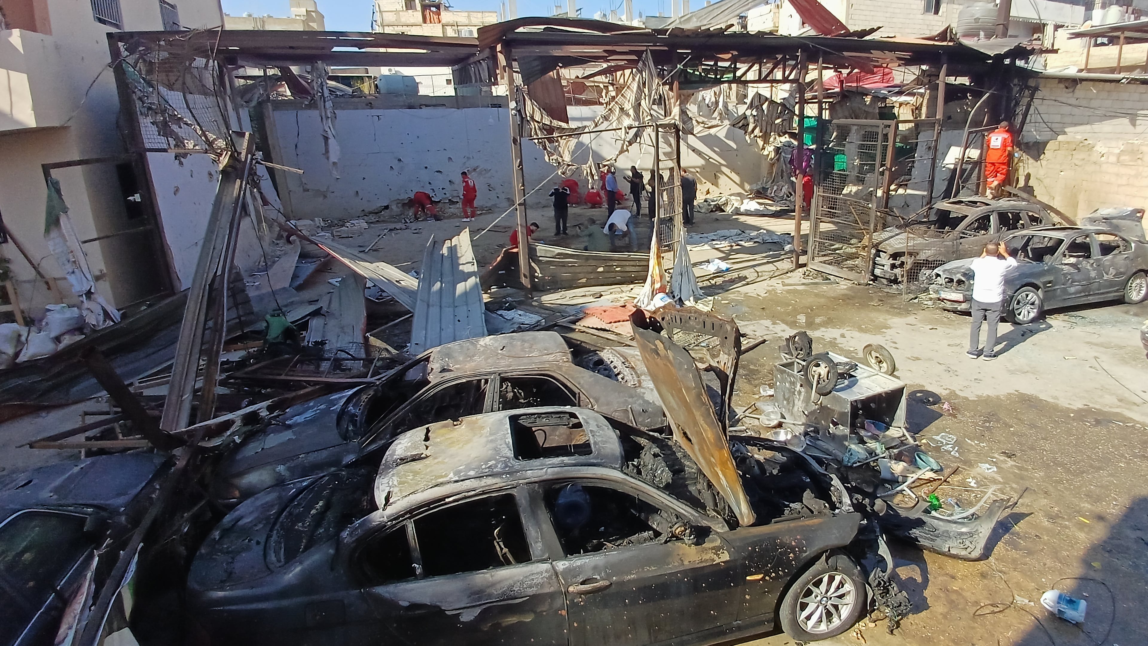 Palestinian rescue workers check the scene where an Israeli strike on Tuesday night hit the Ein el-Hilweh Palestinian refugee camp, in the southern port city of Sidon, Lebanon, Wednesday, Nov. 19, 2025. (AP Photo/Mohammed Zaatari)