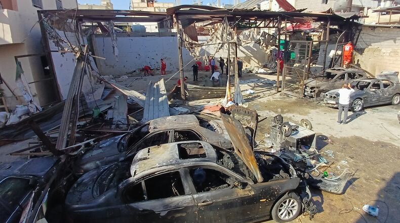 Palestinian rescue workers check the scene where an Israeli strike on Tuesday night hit the Ein el-Hilweh Palestinian refugee camp, in the southern port city of Sidon, Lebanon, Wednesday, Nov. 19, 2025. (AP Photo/Mohammed Zaatari)