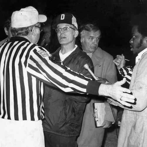 Douglass football coach Charlie Brannon argues with officials in 1975. (AJC file)