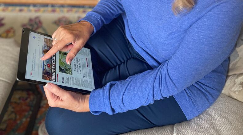 June Sullenger, a subscriber to The Atlanta Journal-Constitution, views our ePaper digital edition recently.