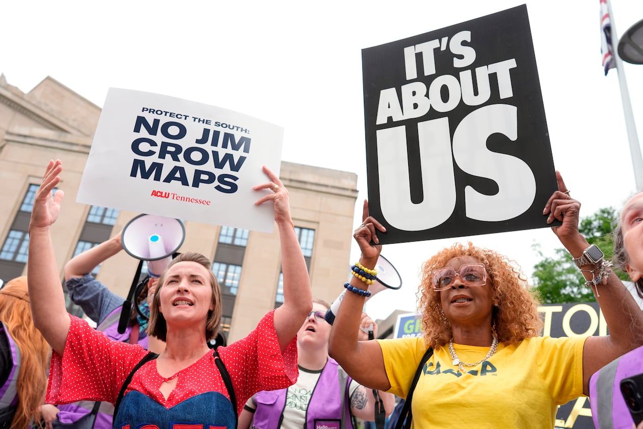 Mandy Cook (left) and Cheryl Woodard hold signs during a rally against a special session of the Tennessee state legislature to redraw U.S. congressional voting maps Tuesday, May 5, 2026, in Nashville, Tennessee. (George Walker IV/AP)