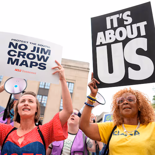 Mandy Cook (left) and Cheryl Woodard hold signs during a rally against a special session of the Tennessee state legislature to redraw U.S. congressional voting maps Tuesday, May 5, 2026, in Nashville, Tennessee. (George Walker IV/AP)