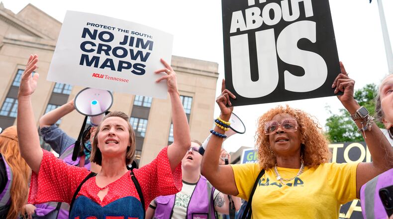 Mandy Cook (left) and Cheryl Woodard hold signs during a rally against a special session of the Tennessee state legislature to redraw U.S. congressional voting maps Tuesday, May 5, 2026, in Nashville, Tennessee. (George Walker IV/AP)