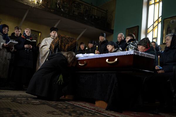 Yulia cries at the coffin of her boyfriend Oleksandr Samoilovich, 18, a Ukrainian soldier of 1st Separate Assault Regiment of Dmytro Kotsiubailo, during farewell ceremony in Slavuta, Ukraine, Friday, April 11, 2025. (AP Photo/Anna Donets)