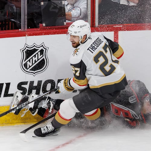 Vegas Golden Knights' Shea Theodore, left, and Carolina Hurricanes' Nikolaj Ehlers, right, collide during the second period in Game 1 of the NHL hockey Stanley Cup Final series in Raleigh, N.C., Tuesday, June 2, 2026. (AP Photo/Ben McKeown)