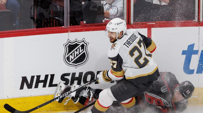 Vegas Golden Knights' Shea Theodore, left, and Carolina Hurricanes' Nikolaj Ehlers, right, collide during the second period in Game 1 of the NHL hockey Stanley Cup Final series in Raleigh, N.C., Tuesday, June 2, 2026. (AP Photo/Ben McKeown)