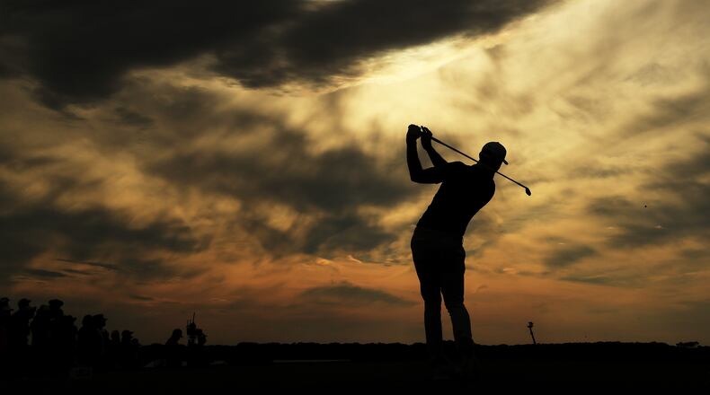 A beautiful day for some ugly scores: That's Dustin Johnson hitting from the 15th tee Saturday at Shinnecock Hills. (Andrew Redington/Getty Images)