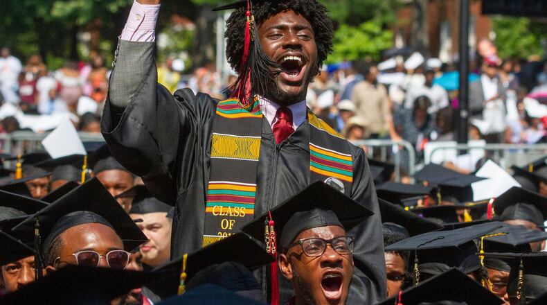 Morehouse Class of 2019 graduates react after hearing billionaire technology investor and philanthropist Robert F. Smith say he will provide grants to wipe out the student debt of their entire graduating class at Morehouse College commencement in Atlanta on  May 19.