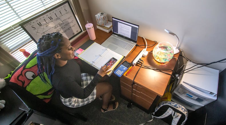Kennesaw State University Miyanna Clements looks over her school work in her room Friday, November 13, 2020. students. (Steve Schaefer for The Atlanta Journal-Constitution)