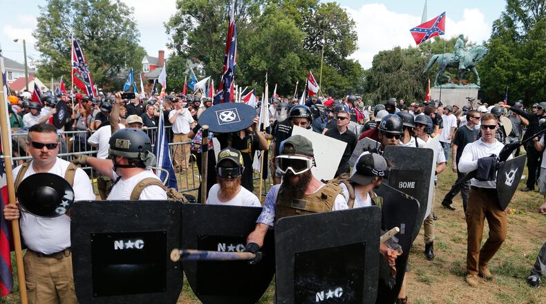 White nationalist demonstrators hold their ground as they clash with counter demonstrators in Lee Park in Charlottesville, Va. on Aug. 12, 2017.