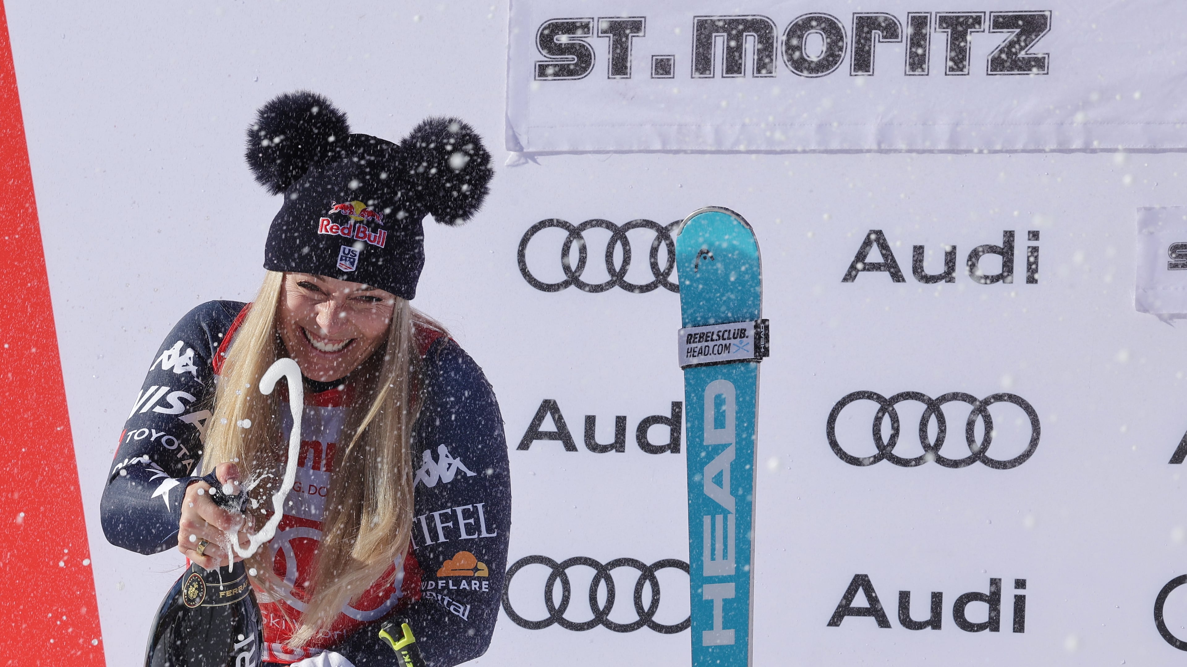 United States' Lindsey Vonn sprays sparkling wine as she celebrates after finishing second in a alpine ski, women's World Cup downhill, in St. Moritz, Switzerland, Saturday Dec. 13, 2025. (AP Photo/Luciano Bisi)