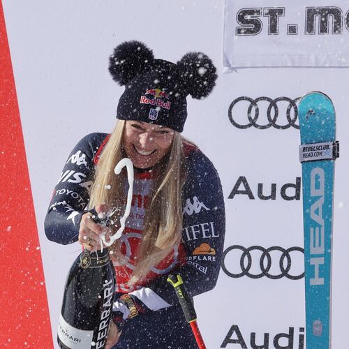 United States' Lindsey Vonn sprays sparkling wine as she celebrates after finishing second in a alpine ski, women's World Cup downhill, in St. Moritz, Switzerland, Saturday Dec. 13, 2025. (AP Photo/Luciano Bisi)