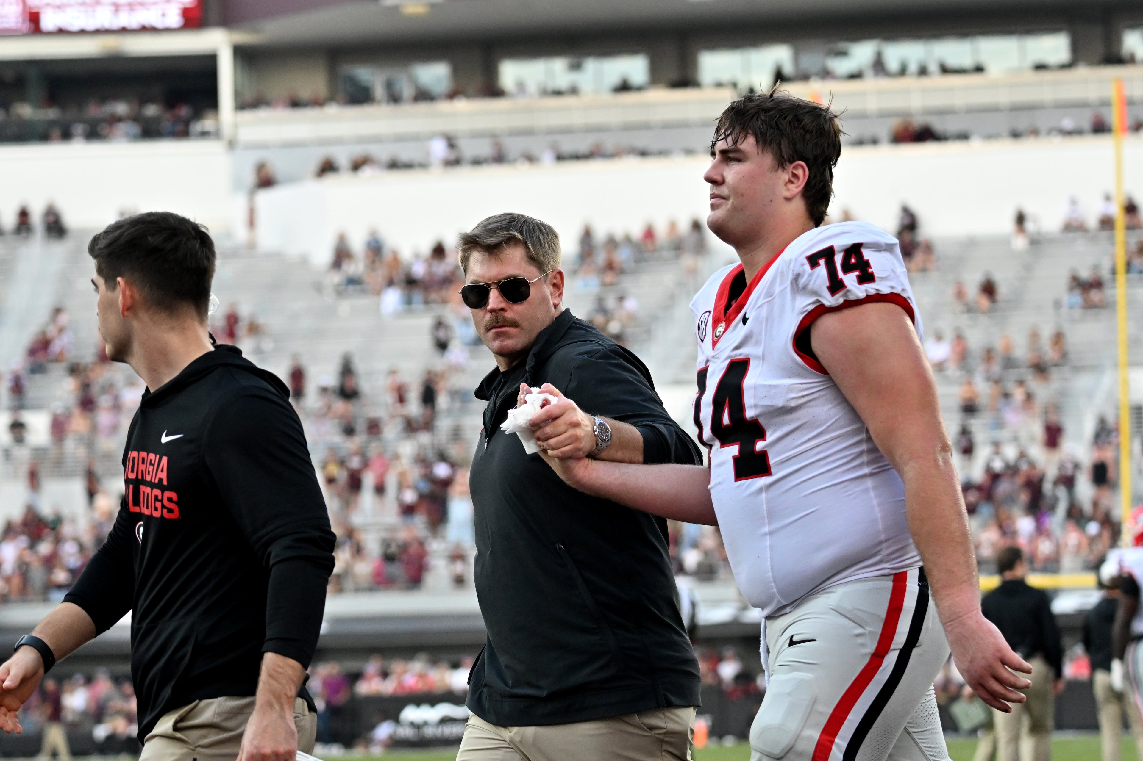Georgia offensive lineman Drew Bobo (74) leaves after his injury during the second half in an NCAA football game at Davis Wade Stadium, Saturday, November 8, 2025, in Starkville, Mississippi. Georgia won 41-21 over Mississippi State. (Hyosub Shin / AJC)