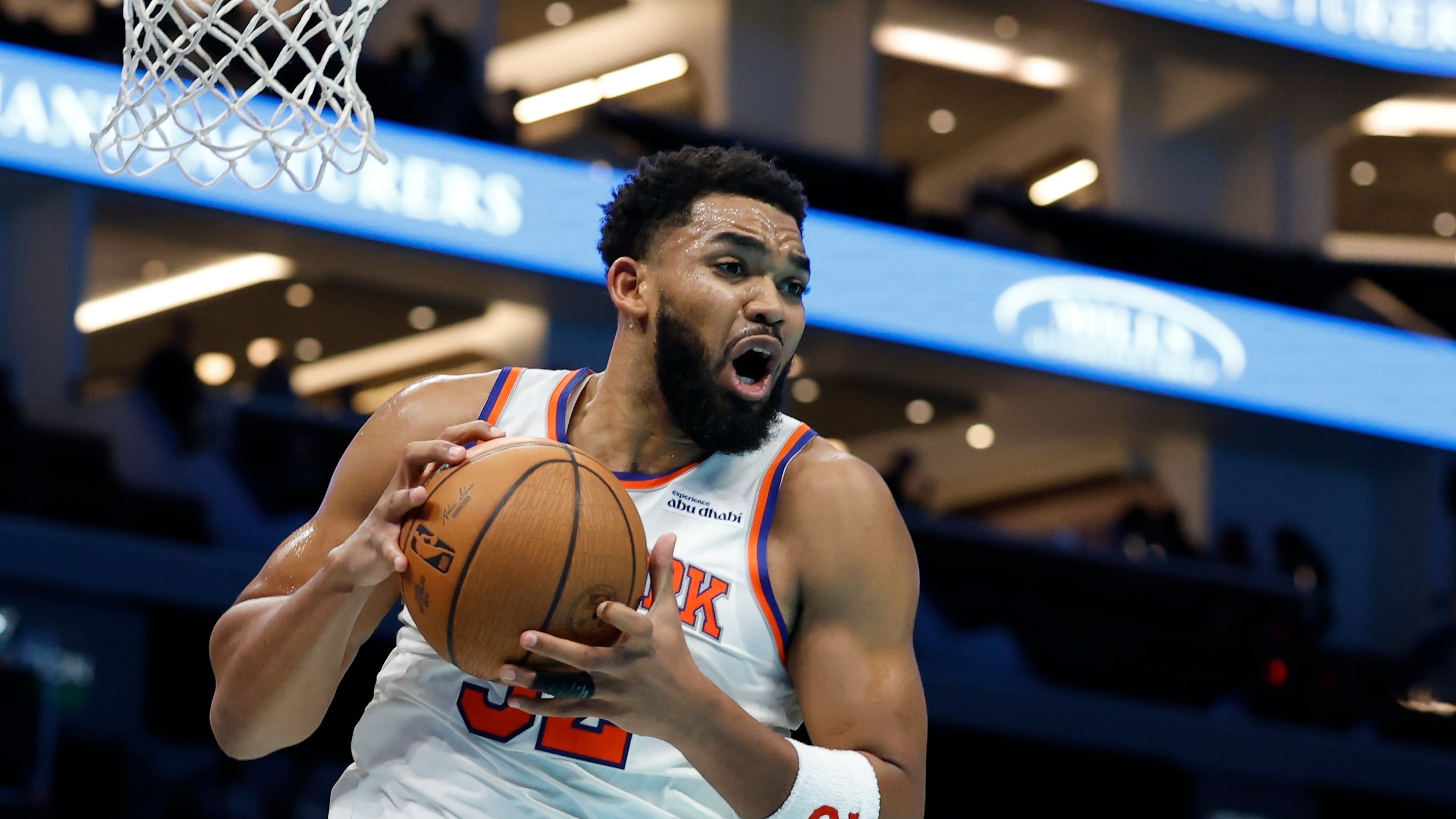New York Knicks center Karl-Anthony Towns pulls down an offensive rebound during the second half of an Emirates NBA Cup basketball game against the Charlotte Hornets in Charlotte, N.C., Wednesday, Nov. 26, 2025. (AP Photo/Nell Redmond)