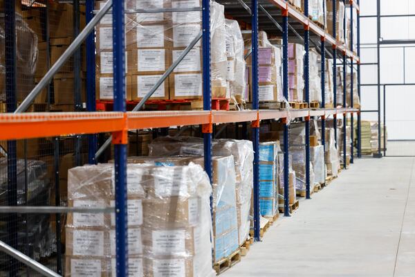 Boxes of election records, including records from 2020, are held in a locked cage at the Fulton County clerk's warehouse. (Arvin Temkar/AJC)