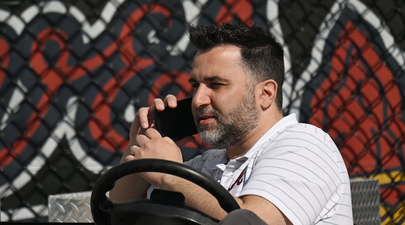 Atlanta Braves general manager Alex Anthopoulos talks on the phone during spring training workouts at CoolToday Park, Wednesday, Feb. 21, 2024, in North Port, Florida. (Hyosub Shin / Hyosub.Shin@ajc.com)