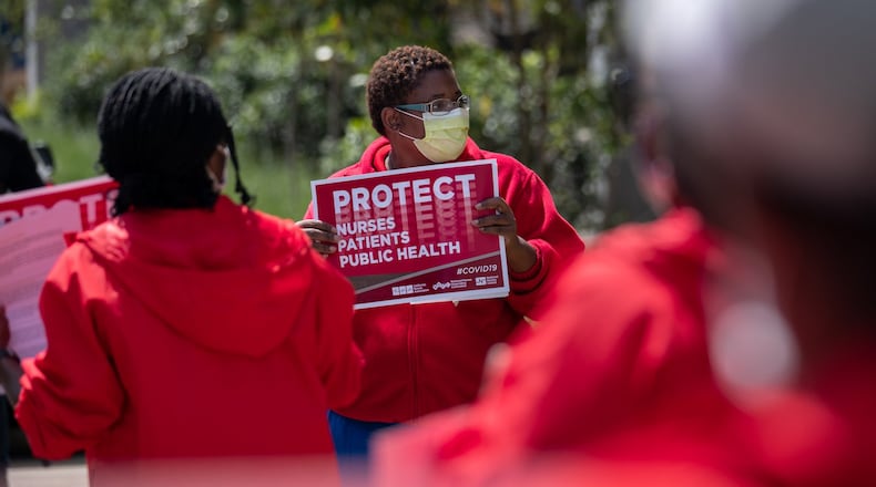 Dana Horton, a registered nurse at the Atlanta VA Medical Center and a representative of National Nurses United’s Atlanta chapter, protests with a handful of other nurses outside the Decatur hospital on Friday. Ben@BenGray.com for the Atlanta Journal-Constitution