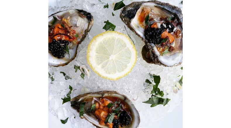 Uni Oysters with truffle ginger chili lime sauce, topped with lemongrass, Vietnamese mint, crispy shallots and caviar. / Courtesy of Amkha Omakase