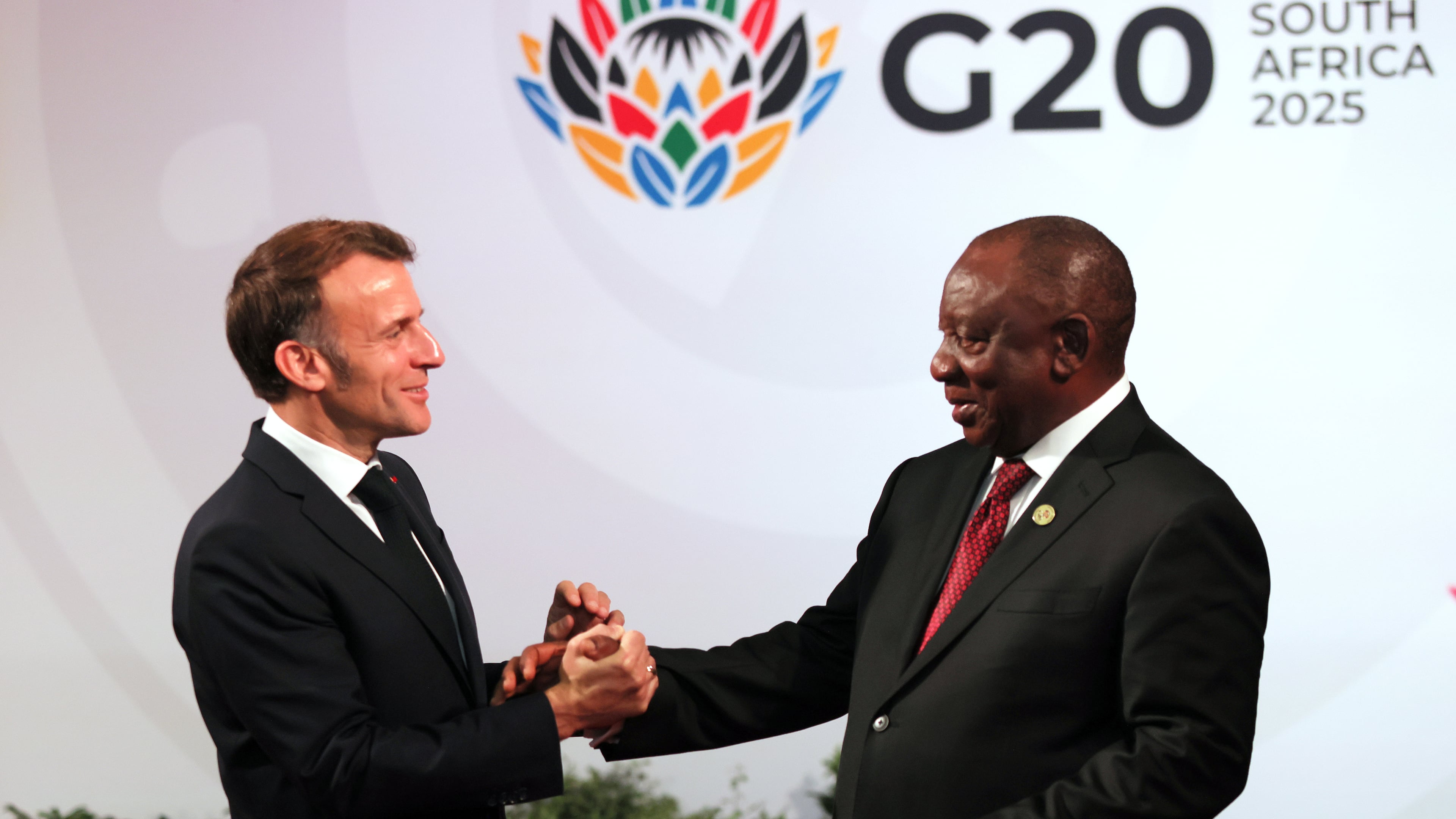 South African Cyril Ramaphosa, right, welcomes welcomes French President Emmanuel Macron, on the opening day of the G20 Summit, in Johannesburg, South Africa, Saturday, Nov. 22, 2025. (Halden Krog/Pool Photo via AP)