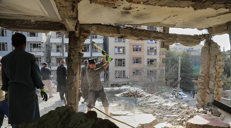 Residents remove debris from a house damaged by Wednesday's two drone strikes, in Kabul, Afghanistan, Thursday, Oct. 16, 2025. (AP Photo/Siddiqullah Alizai)