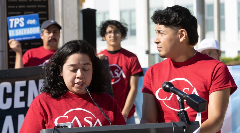 TPS activists Alberto Feregrino (L) and Stephanie Contreras talk at a press conference at liberty plaza near the state capital Thursday, September 15, 2022.   Steve Schaefer/steve.schaefer@ajc.com)