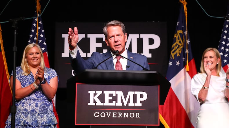 052422 Atlanta: Governor Brian Kemp delivers his election night party speech with First Lady Marty Kemp and his daughter Jarrett standing on stage at the College Football Hall of Fame on Tuesday, May 24, 2022, in Atlanta.    “Curtis Compton / Curtis.Compton@ajc.com”