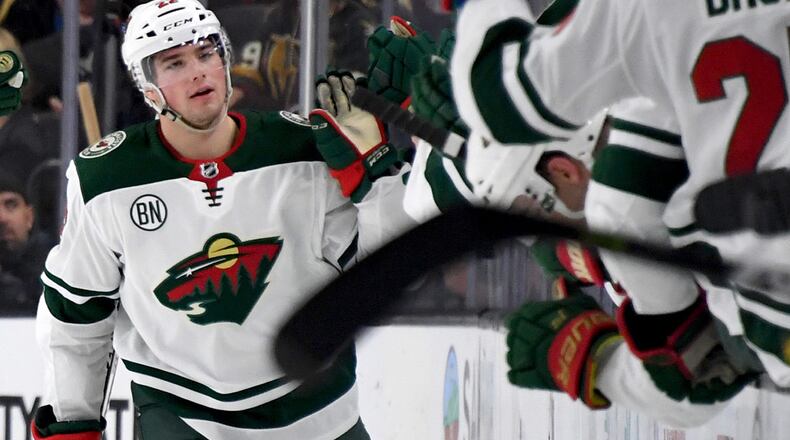 FILE PHOTO: Kevin Fiala #22 of the Minnesota Wild celebrates with teammates on the bench after scoring. Fiala has a new four-legged teammate -- Breezer a service dog-in-training.