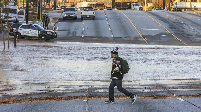 Michael Wilson tries to find an alternate way around the flooded Buford Highway. Buford Highway was flooded just north of I-285 in DeKalb County due to a water main break on Wednesday, March 7, 2018. DeKalb County schools closed early because of the break, giving the district yet another day for students to make up, in a year that’s already had plenty of those. JOHN SPINK/JSPINK@AJC.COM