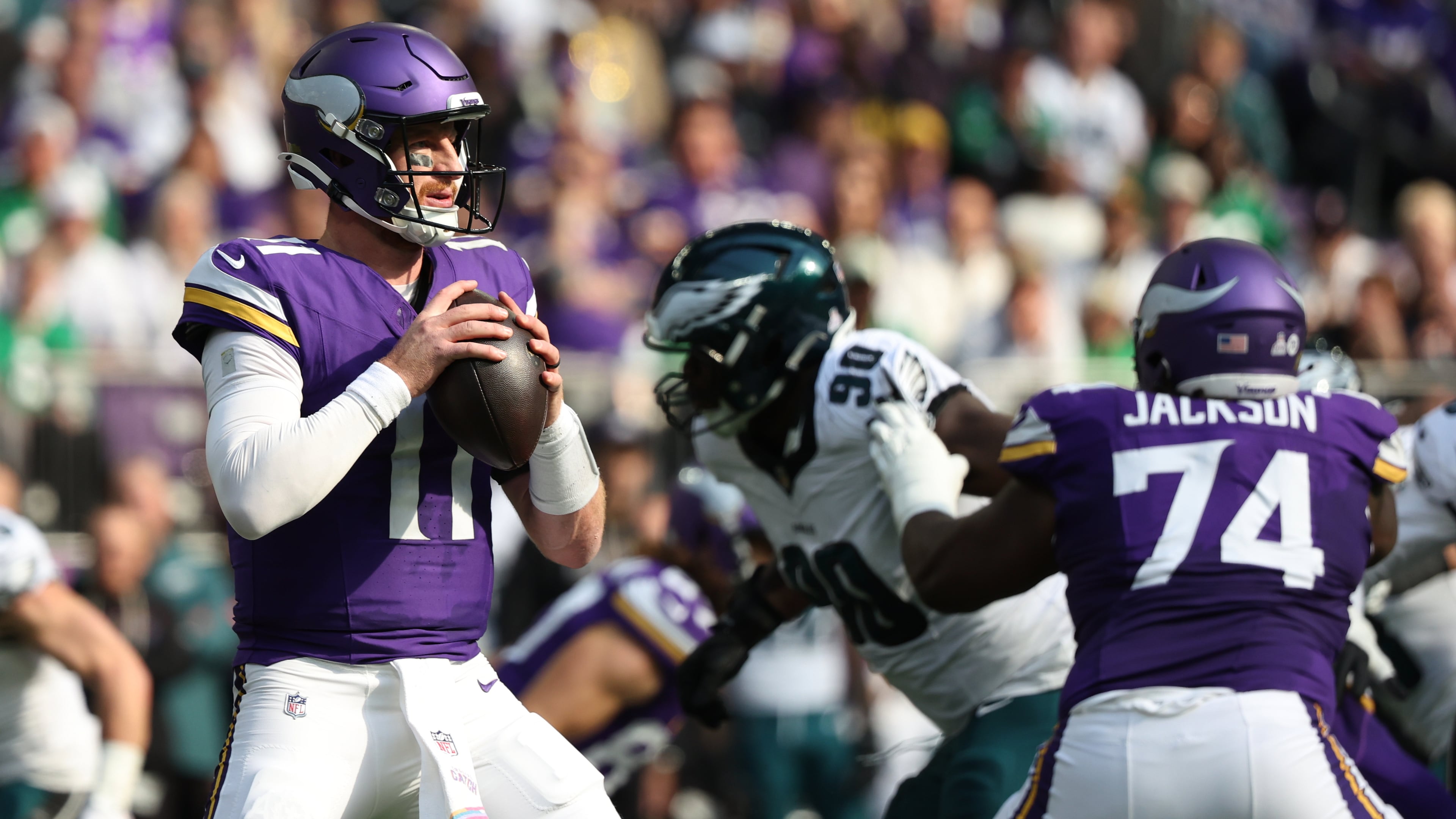 Minnesota Vikings quarterback Carson Wentz (11) prepares to throw a pass during the first half of an NFL football game against the Philadelphia Eagles, Sunday, Oct. 19, 2025, in Minneapolis. (AP Photo/Ellen Schmidt)