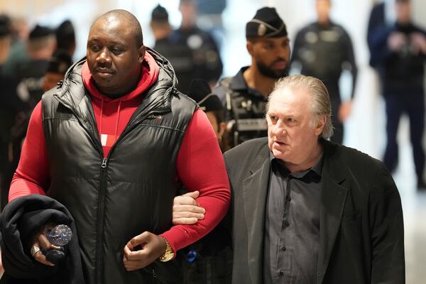 Actor Gerard Depardieu, right, arrives at his trial for the alleged sexual assaults of two women on a film set in 2021, Thursday, March 27, 2025 in Paris. (AP Photo/Aurelien Morissard)