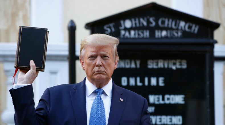 President Donald Trump holds a Bible as he visits outside St. John's Church across Lafayette Park from the White House Monday, June 1, 2020, in Washington. Part of the church was set on fire during protests on Sunday night. (AP Photo/Patrick Semansky)