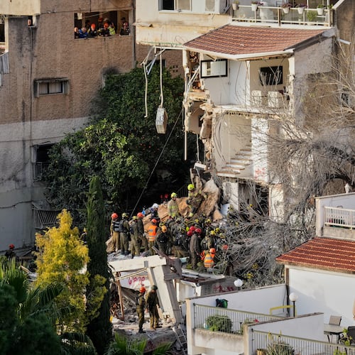 Israeli rescue teams search for missing people amid the rubble of a residential building a day after it was struck by an Iranian missile in Haifa, Israel, Monday, April 6, 2026. (AP Photo/Ariel Schalit)