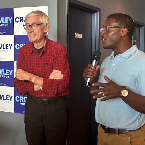 Wisconsin Gov. Tony Evers, left, campaigns with Democratic candidate for Governor David Crowley, right, Monday, Aug. 10, 2026, in Madison, Wis. (AP Photo/Scott Bauer)