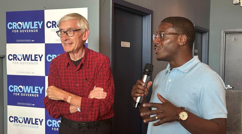 Wisconsin Gov. Tony Evers, left, campaigns with Democratic candidate for Governor David Crowley, right, Monday, Aug. 10, 2026, in Madison, Wis. (AP Photo/Scott Bauer)