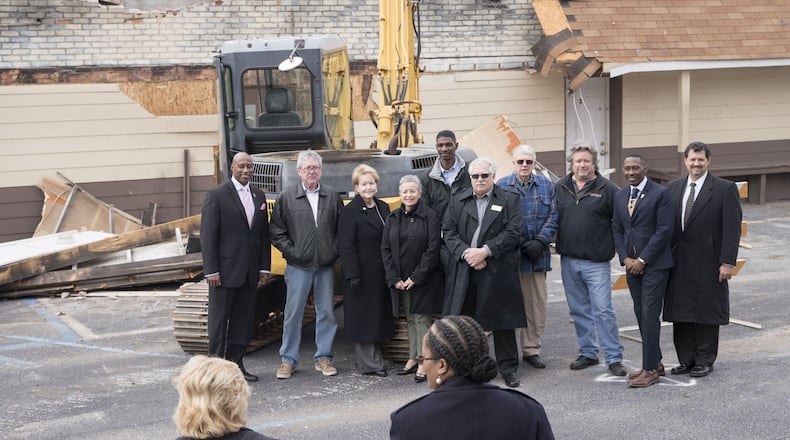 01/16/2018 — Jonesboro, GA - City leaders of Jonesboro, including mayor Joy Brantley Day, third from left, and the city manager, Ricky Clark, Jr., second from right, pose for a photo following the demolition of buildings along Broad Street in downtown Jonesboro, Tuesday, January 16, 2018. The city of Jonesboro is hoping to attract its residence and entice its visitors by upping its downtown revitalization efforts. They will start the process by tearing down a row of dilapidated buildings on Broad Street. ALYSSA POINTER/ALYSSA.POINTER@AJC.COM