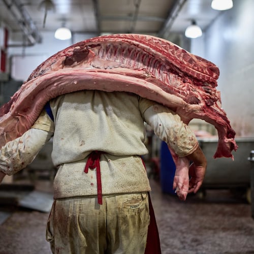 A worker carries pork inside a butcher shop at the Mataderos meat market in Buenos Aires, Argentina, Thursday, May 14, 2026. (AP Photo/Rodrigo Abd)