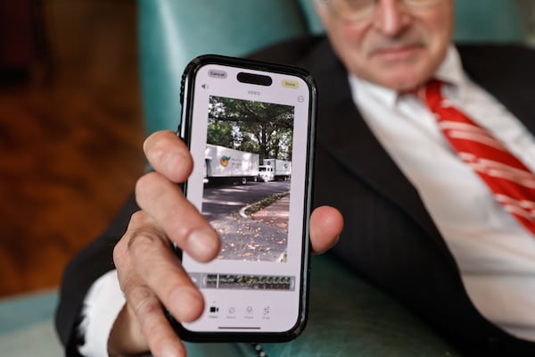 Sheffield Hale, president and CEO of the Atlanta History Center, shows a video of the four truckloads filled with archival railroad documents that the Atlanta History Center received. (Natrice Miller/AJC)
