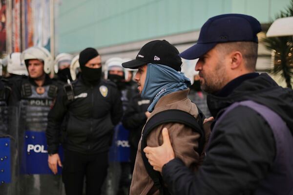 A man is detained by police during a protest called by university students in Istanbul, Turkey, Thursday, March 27, 2025, after Istanbul's Mayor Ekrem Imamoglu was arrested and sent to prison. (AP Photo/Francisco Seco)