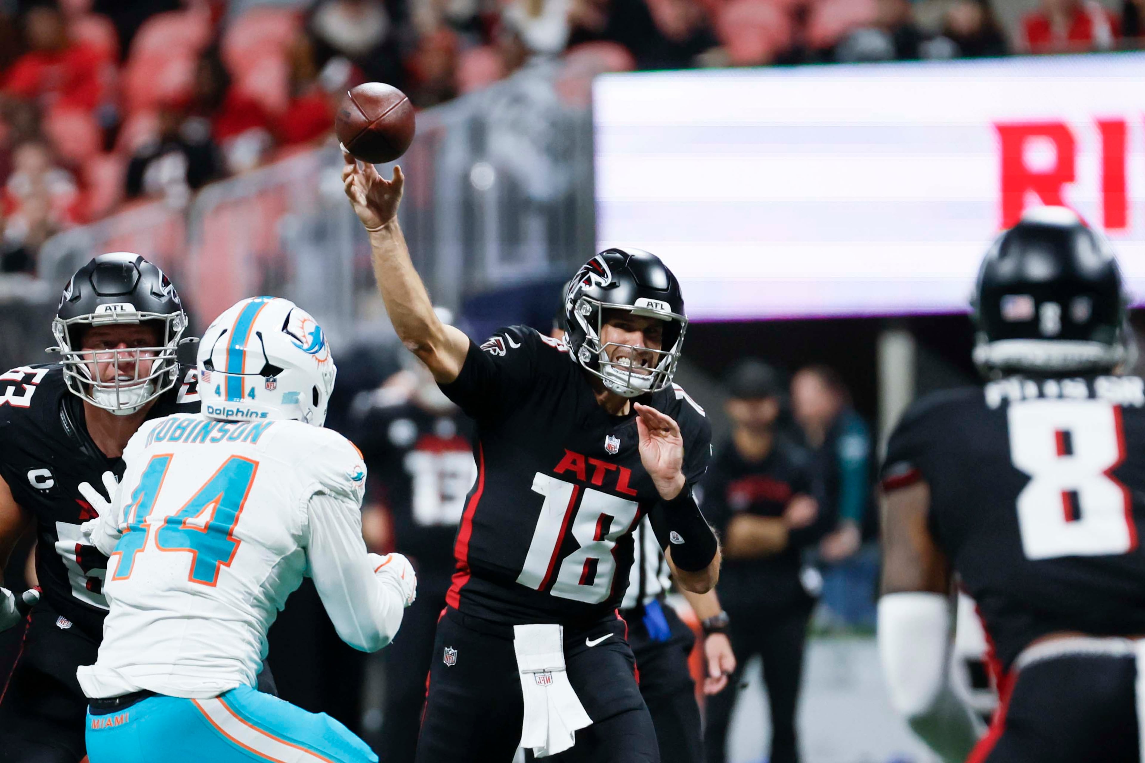 Atlanta Falcons quarterback Kirk Cousins (center) attempts a pass during the second half of an NFL game against the Miami Dolphins at Mercedes-Benz Stadium in Atlanta on Sunday, Oct. 26, 2025. (Miguel Martinez/AJC)