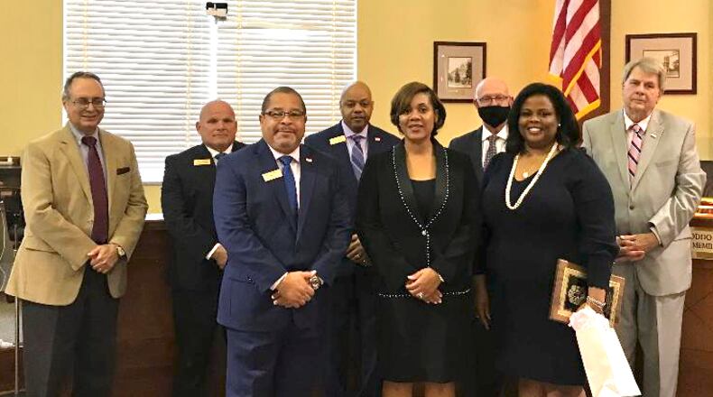 Fayetteville Mayor Ed Johnson and the City Council recognized incoming Municipal Court Judge Nailah Grant McFarlane (center) and her predecessor, Rhonda Kreuziger (right), on Oct. 1. Courtesy City of Fayetteville