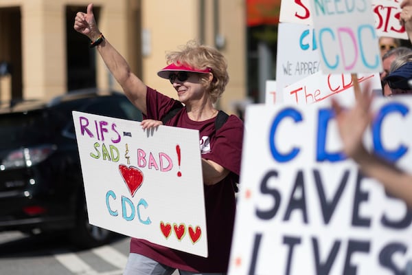 Lynn Sokler, who retired from the CDC three weeks ago after working there almost two decades, protests with others in support of the Centers for Disease Control and Prevention in front of the headquarters in Atlanta, Tuesday, April 1, 2025. (AP Photo/Ben Gray)